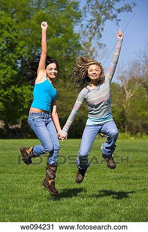 Caucasion teenage girsl playing in the park View Large Photo Image Stock Image - Caucasion teenage girsl playing in the park. Fotosearch
