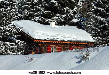 Chalet covered with a thick layer of snow in a wintery forest, Givrine, St Cergue, Jura, Switzerland View Large Photo Image Stock Image - Chalet covered with a thick layer of snow in a wintery forest, Givrine, St Cergue, Jura, Switzerland. Fotosearch