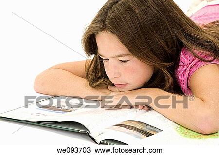 Child laying on a white background and reading a book View Large Photo Image Stock Image - Child laying on a white background and reading a book. Fotosearch