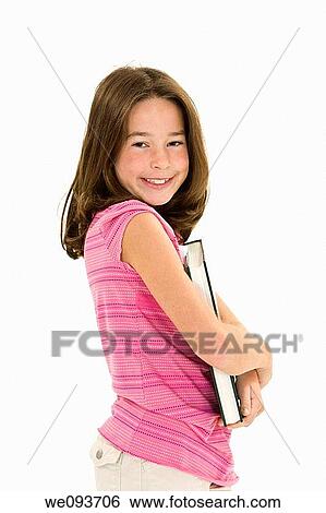 Stock Photograph - Child standing holding books on white background. Fotosearch