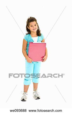 Stock Photo - Child standing on a white background holding school books. Fotosearch