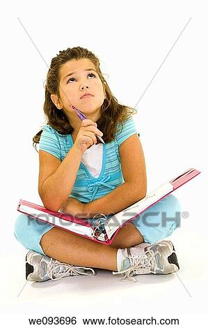 Stock Photograph - Child working on homework on white background. Fotosearch