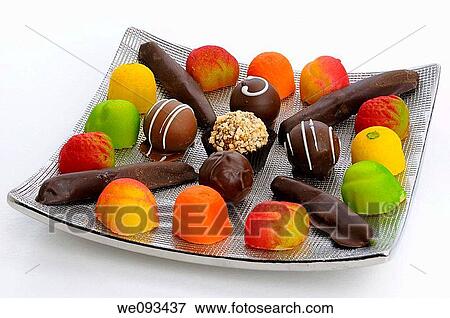 Chocolate truffles candied orange rind and marzipan candies on a silver plate on white View Large Photo Image Stock Photo - Chocolate truffles candied orange rind and marzipan candies on a silver plate on white. Fotosearch