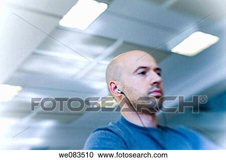 Close-up of a balding young man wearing headphones. View Large Photo Image Stock Image - Close-up of a balding young man wearing headphones.. Fotosearch
