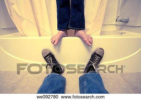 Close-up of a man's and woman's feet in a bathroom View Large Photo Image Stock Image - Close-up of a man's and woman's feet in a bathroom. Fotosearch