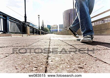 Close-up of a man's legs and feet on a footbridge in the downtown area of a city. View Large Photo Image Stock Photography - Close-up of a man's legs and feet on a footbridge in the downtown area of a city.. Fotosearch