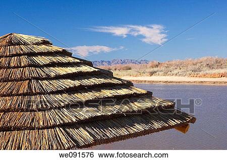 Close-up of a thatched roof palapa hut along the Colorado River in the Mojave Desert, Arizona View Large Photo Image Stock Photograph - Close-up of a thatched roof palapa hut along the Colorado River in the Mojave Desert, Arizona. Fotosearch