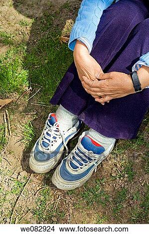 Close-up of a woman's hands and tennis shoed feet. View Large Photo Image Picture - Close-up of a woman's hands and tennis shoed feet.. Fotosearch