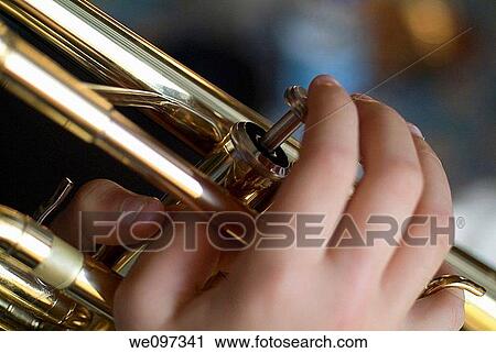 Close-up of boy s finger playing the trumpet View Large Photo Image Stock Image - Close-up of boy s finger playing the trumpet. Fotosearch