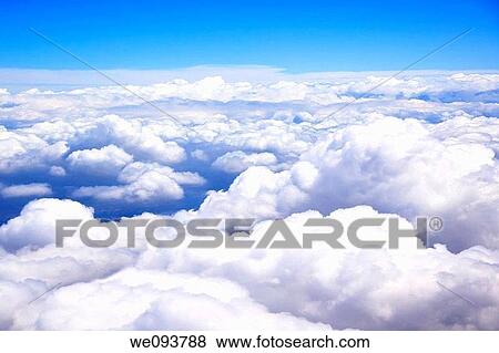 Clouds as viewed out the window of an airplane View Large Photo Image Stock Photo - Clouds as viewed out the window of an airplane. Fotosearch