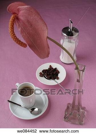 Stock Image - Coffee, raisins and Anthurium flower. Fotosearch