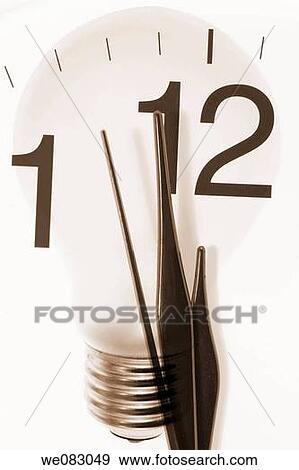 Stock Photo - Composite of Clock Hands and Light Bulb. Fotosearch