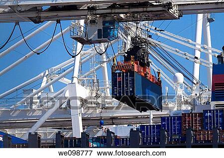 Container crane lifting portainer shipping container from cargo ship View Large Photo Image Stock Photo - Container crane lifting portainer shipping container from cargo ship. Fotosearch