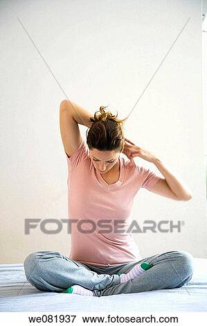 contemporary, cross-legged, Arms raised View Large Photo Image Stock Photo - contemporary, cross-legged, Arms raised. Fotosearch