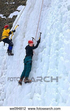 Couple of ice climbers front pointing up an ice wall at Tiffany Falls Ontario Canada View Large Photo Image Stock Image - Couple of ice climbers front pointing up an ice wall at Tiffany Falls Ontario Canada. Fotosearch