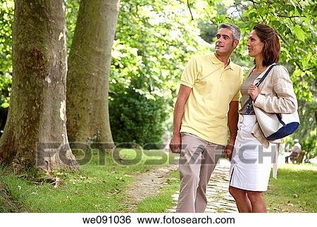 Couple walking in a garden, spa, Lierganes, Cantabria, Spain View Large Photo Image Stock Photograph - Couple walking in a garden, spa, Lierganes, Cantabria, Spain. Fotosearch