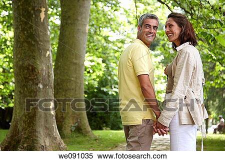 Couple walking in a garden, spa, Lierganes, Cantabria, Spain View Large Photo Image Stock Photography - Couple walking in a garden, spa, Lierganes, Cantabria, Spain. Fotosearch