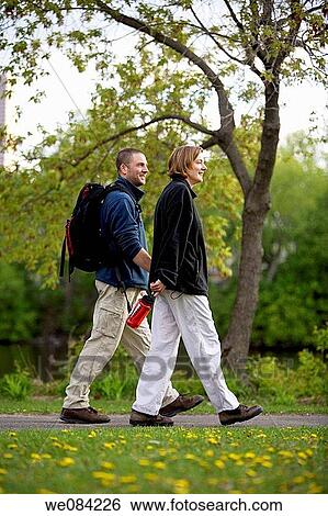 COUPLE WALKING IN MINNEAPOLIS PARK View Large Photo Image Stock Photograph - COUPLE WALKING IN MINNEAPOLIS PARK. Fotosearch