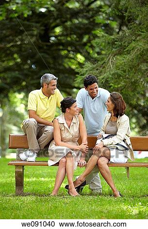Couples sitting on bench in a garden, spa, Lierganes, Cantabria, Spain View Large Photo Image Stock Image - Couples sitting on bench in a garden, spa, Lierganes, Cantabria, Spain. Fotosearch