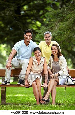 Couples sitting on bench in a garden, spa, Lierganes, Cantabria, Spain View Large Photo Image Stock Photo - Couples sitting on bench in a garden, spa, Lierganes, Cantabria, Spain. Fotosearch