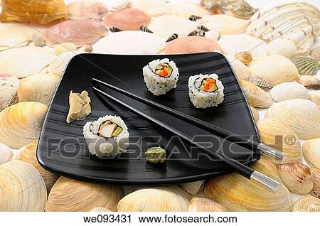 Crab Uramaki sushi and chopsticks on a black plate surrounded by sea shells View Large Photo Image Stock Image - Crab Uramaki sushi and chopsticks on a black plate surrounded by sea shells. Fotosearch