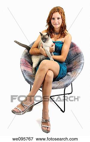 Cut out of teenage girl sitting in a chair with a siamese cat View Large Photo Image Stock Photo - Cut out of teenage girl sitting in a chair with a siamese cat. Fotosearch