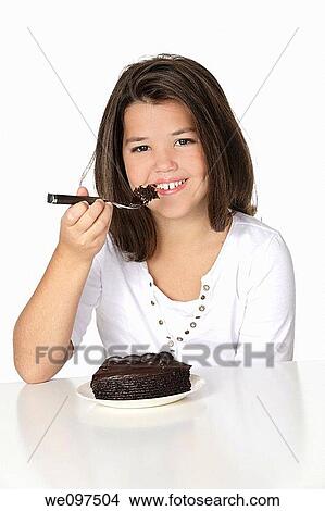 Cute Caucasian child eating a slice of chocolate cake View Large Photo Image Picture - Cute Caucasian child eating a slice of chocolate cake. Fotosearch