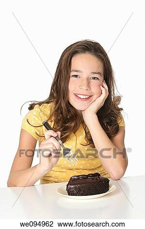 Cute Caucasian child eating a slice of chocolate cake View Large Photo Image Stock Image - Cute Caucasian child eating a slice of chocolate cake. Fotosearch