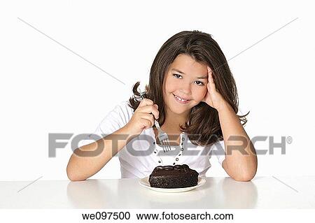 Cute Caucasian child eating a slice of chocolate cake View Large Photo Image Stock Image - Cute Caucasian child eating a slice of chocolate cake. Fotosearch