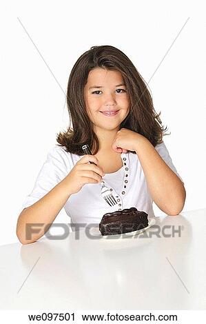 Cute Caucasian child eating a slice of chocolate cake View Large Photo Image Stock Image - Cute Caucasian child eating a slice of chocolate cake. Fotosearch
