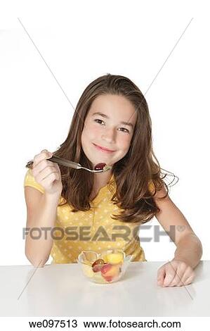 Cute Caucasian girl eating a bowl of fruit View Large Photo Image Stock Image - Cute Caucasian girl eating a bowl of fruit. Fotosearch