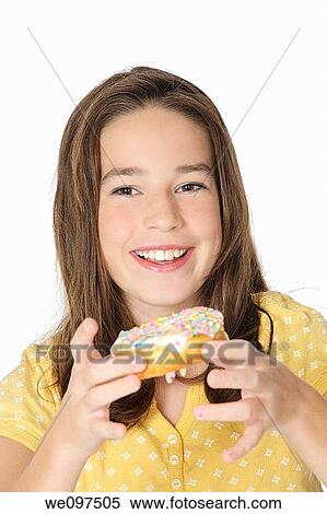 Cute Caucasian girl eating a donut on a white background View Large Photo Image Stock Photography - Cute Caucasian girl eating a donut on a white background. Fotosearch