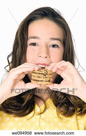 Cute Caucasian girl eating Chocolate Chip Cookies View Large Photo Image Stock Photo - Cute Caucasian girl eating Chocolate Chip Cookies. Fotosearch