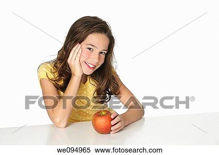 Cute Caucasian girl happy about eating an apple View Large Photo Image Stock Photography - Cute Caucasian girl happy about eating an apple. Fotosearch