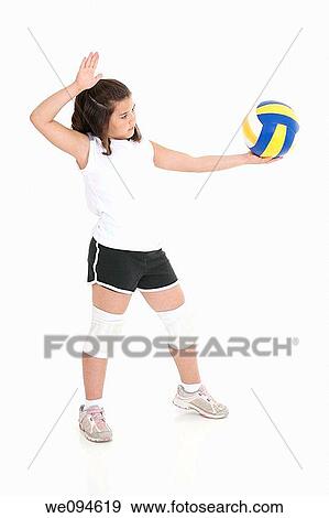 Cute Caucasian girl serving the ball in volleyball View Large Photo Image Stock Photo - Cute Caucasian girl serving the ball in volleyball. Fotosearch