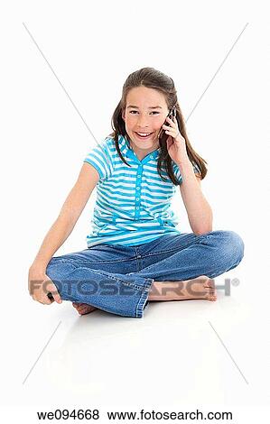 Cute Caucasian girl talking on a cell phone View Large Photo Image Stock Photo - Cute Caucasian girl talking on a cell phone. Fotosearch