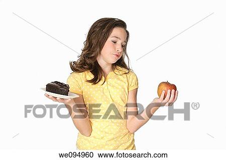 Cute Caucasian girl trying to make a decision between eating healthy or not View Large Photo Image Stock Image - Cute Caucasian girl trying to make a decision between eating healthy or not. Fotosearch