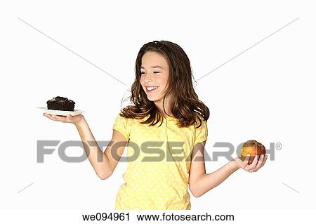 Cute Caucasian girl trying to make a decision between eating healthy or not View Large Photo Image Stock Image - Cute Caucasian girl trying to make a decision between eating healthy or not. Fotosearch