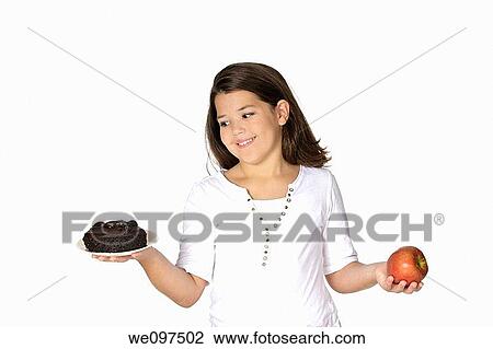 Stock Image - Cute Caucasian girl trying to make a decision between eating healthy or not. Fotosearch