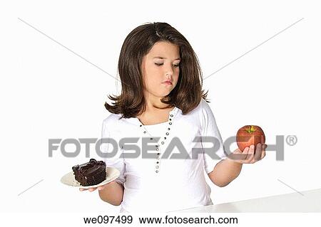 Cute Caucasian girl trying to make a decision between eating healthy or not View Large Photo Image Stock Photo - Cute Caucasian girl trying to make a decision between eating healthy or not. Fotosearch