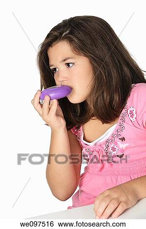 Cute Caucasian girl using an inhaler for Asthma View Large Photo Image Stock Photograph - Cute Caucasian girl using an inhaler for Asthma. Fotosearch