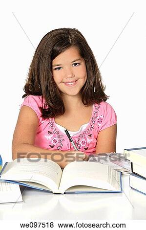 Stock Photo - Cute Caucasian girl working on homework. Fotosearch