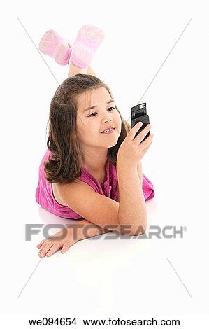 Cute Caucasian girls texting on a cell phone View Large Photo Image Picture - Cute Caucasian girls texting on a cell phone. Fotosearch