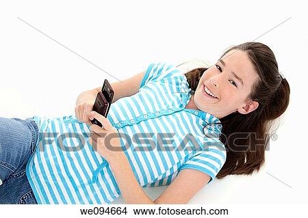 Cute Caucasian girls texting on a cell phone View Large Photo Image Picture - Cute Caucasian girls texting on a cell phone. Fotosearch