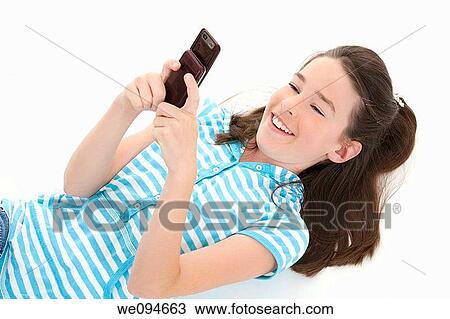 Cute Caucasian girls texting on a cell phone View Large Photo Image Stock Image - Cute Caucasian girls texting on a cell phone. Fotosearch