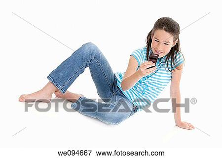 Cute Caucasian girls texting on a cell phone View Large Photo Image Stock Photo - Cute Caucasian girls texting on a cell phone. Fotosearch