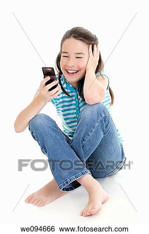 Cute Caucasian girls texting on a cell phone View Large Photo Image Stock Photograph - Cute Caucasian girls texting on a cell phone. Fotosearch
