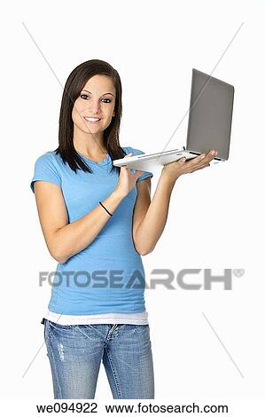 Cute Caucasian student holding a computer on a white background View Large Photo Image Stock Image - Cute Caucasian student holding a computer on a white background. Fotosearch