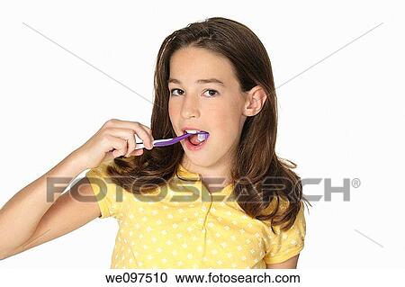 Cute Caucasion girl brushing her teeth isolated on a white background View Large Photo Image Stock Image - Cute Caucasion girl brushing her teeth isolated on a white background. Fotosearch