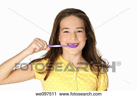 Cute Caucasion girl brushing her teeth isolated on a white background View Large Photo Image Stock Image - Cute Caucasion girl brushing her teeth isolated on a white background. Fotosearch